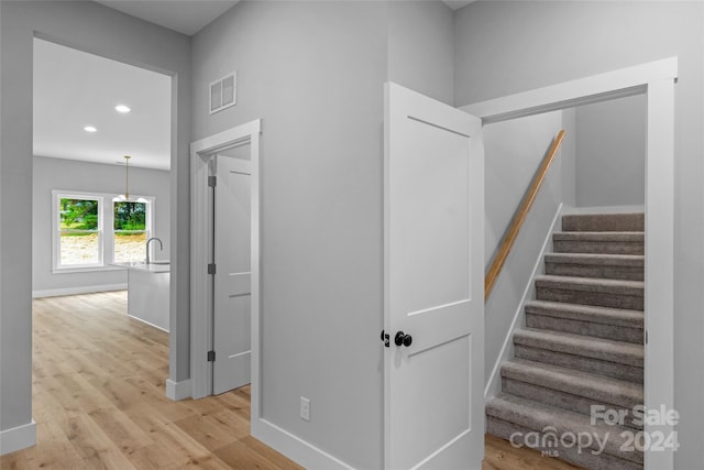 hallway featuring light hardwood / wood-style flooring and sink