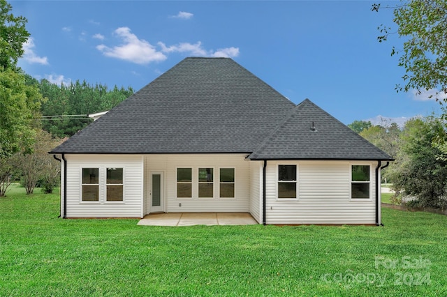 rear view of property with a patio and a yard