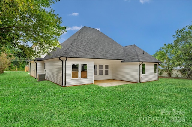 back of property with a yard, a patio, and central air condition unit