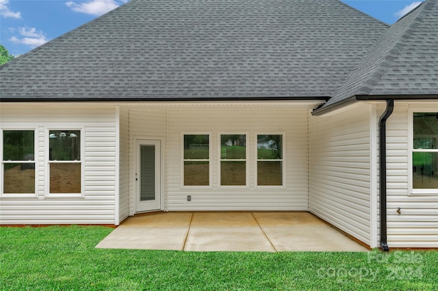 rear view of property with a yard and a patio area