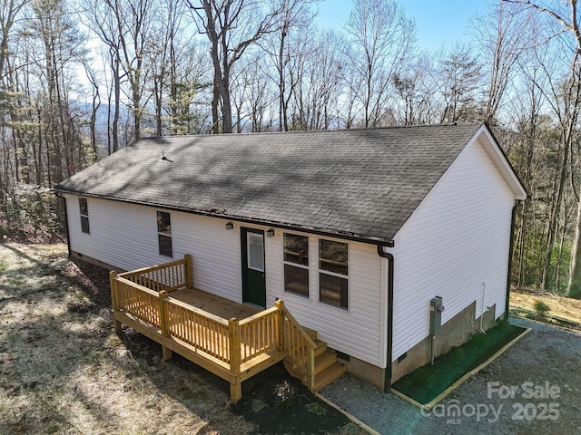 back of property with a wooden deck