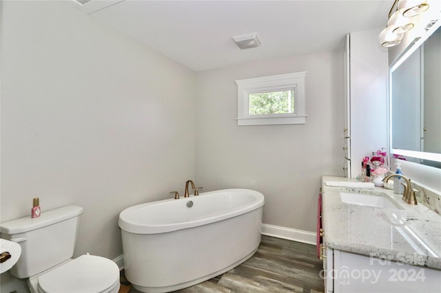 bathroom featuring a tub to relax in, vanity, toilet, and hardwood / wood-style flooring