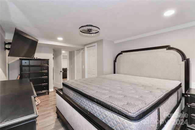 bedroom featuring light wood-type flooring and ornamental molding