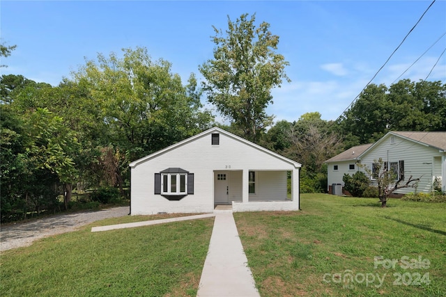 bungalow-style home featuring central AC unit and a front lawn