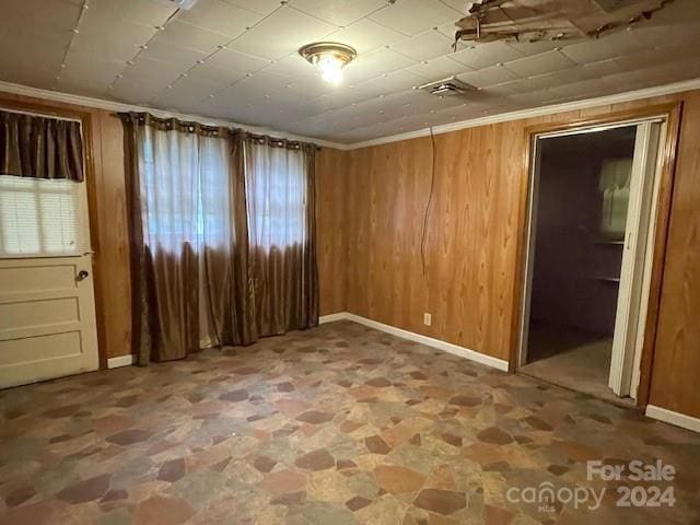 empty room with wood walls and ornamental molding