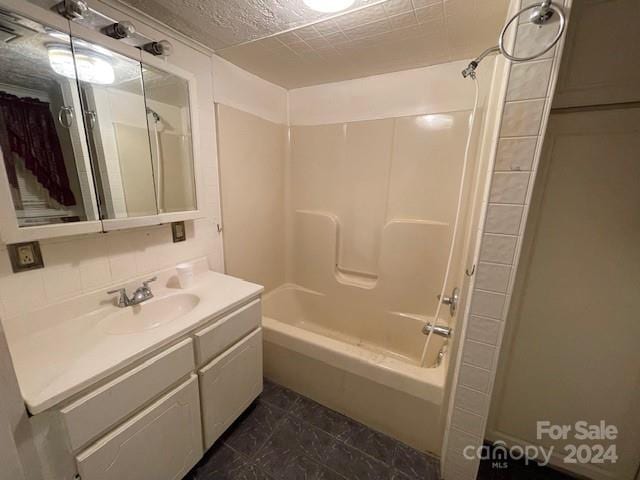 bathroom featuring vanity, shower / bath combination, and backsplash