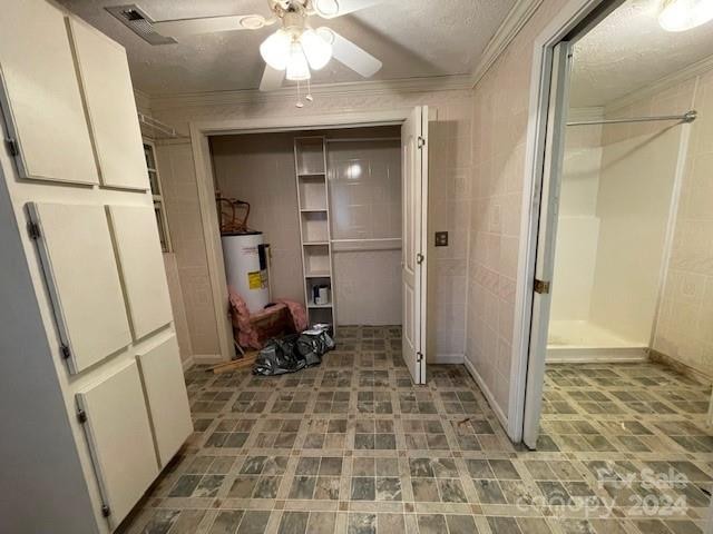 bathroom featuring a shower, crown molding, ceiling fan, a textured ceiling, and water heater