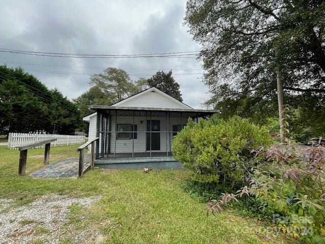 back of house with a lawn