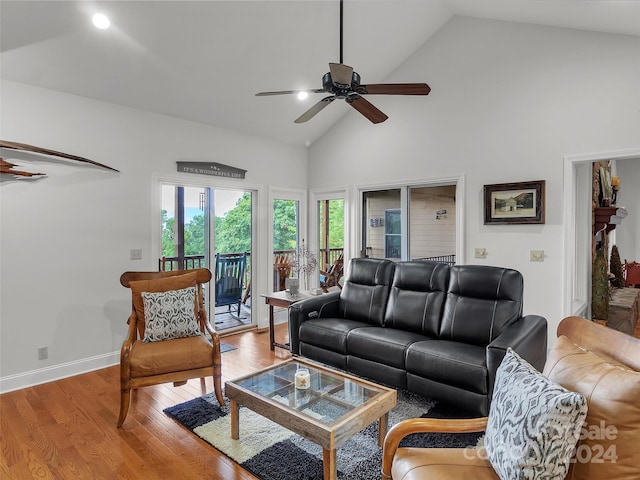 living room with wood-type flooring, high vaulted ceiling, and ceiling fan