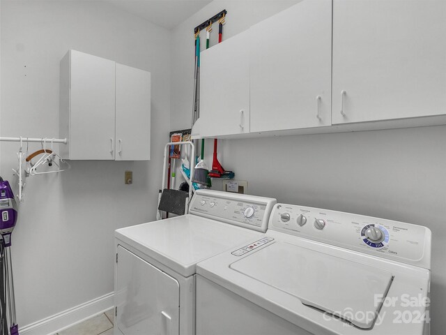 445 Equestrian Dr, Waynesville, NC 28786 - washroom featuring separate washer and dryer, cabinet space, and tile patterned floors
