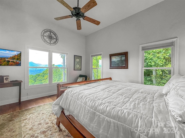 bedroom featuring lofted ceiling, hardwood / wood-style floors, and ceiling fan