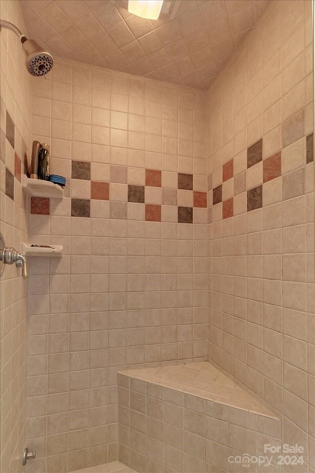 bathroom with a tile shower