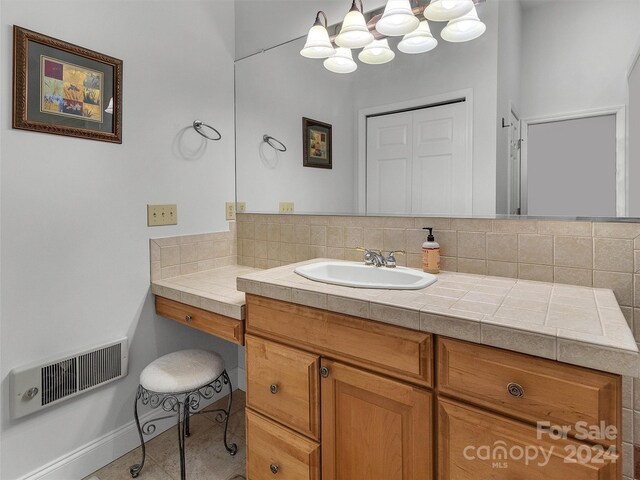 445 Equestrian Dr, Waynesville, NC 28786 - bathroom with tasteful backsplash, vanity, a chandelier, baseboards, and tile patterned floors