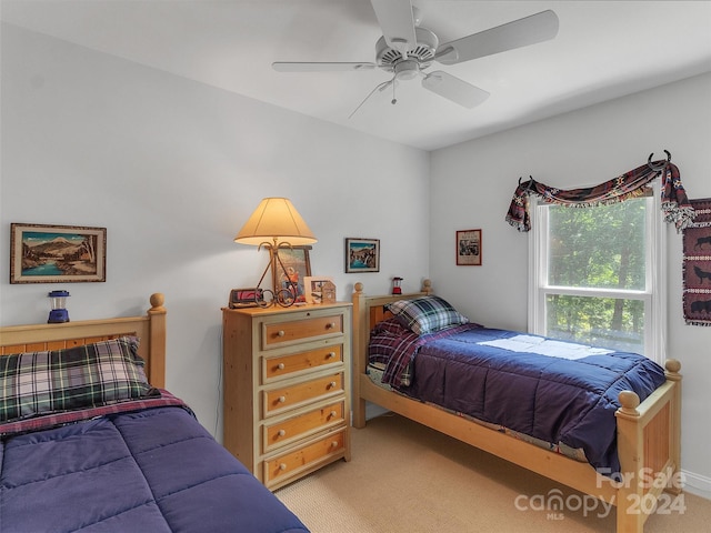 carpeted bedroom featuring ceiling fan