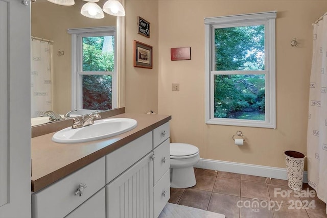 bathroom featuring vanity, tile patterned flooring, and toilet