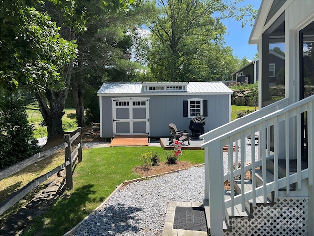 view of yard featuring a storage shed, a deck, and a patio area