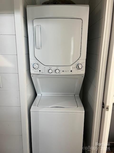 clothes washing area with stacked washer / drying machine