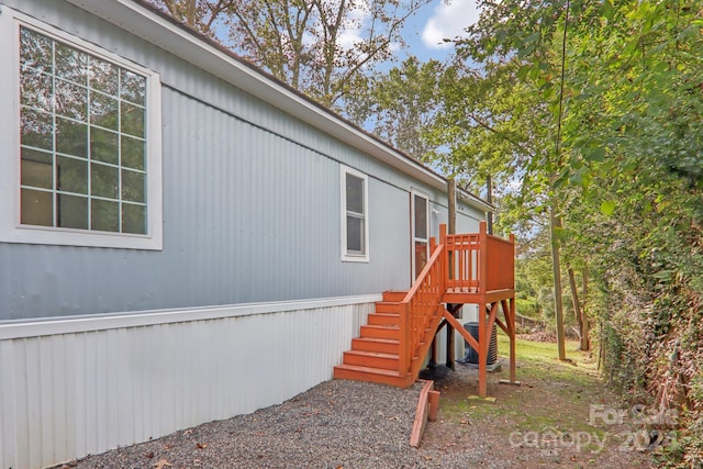 view of side of property featuring a wooden deck