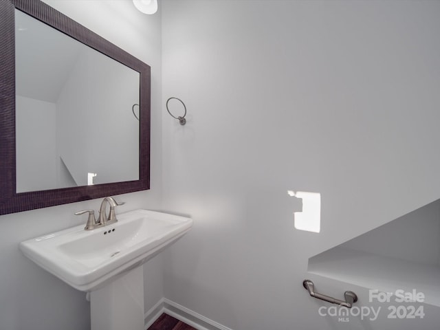 bathroom featuring baseboards and a sink