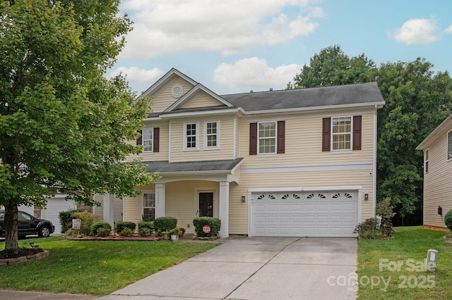 view of front of home with a front yard and a garage