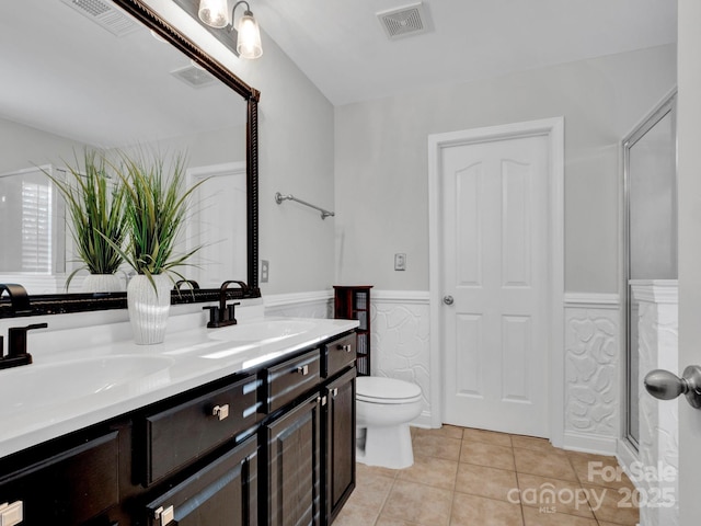 bathroom with toilet, tile patterned floors, an enclosed shower, and vanity