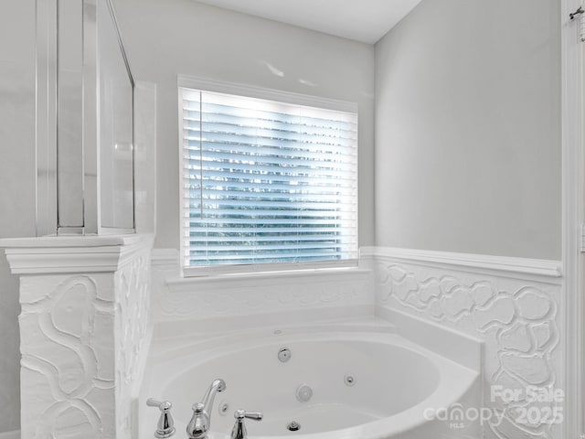 bathroom with a wealth of natural light and a tub to relax in