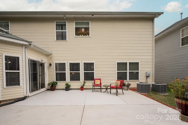 back of house with cooling unit and a patio