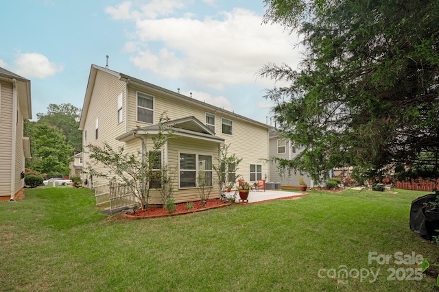 back of house featuring a lawn and a patio