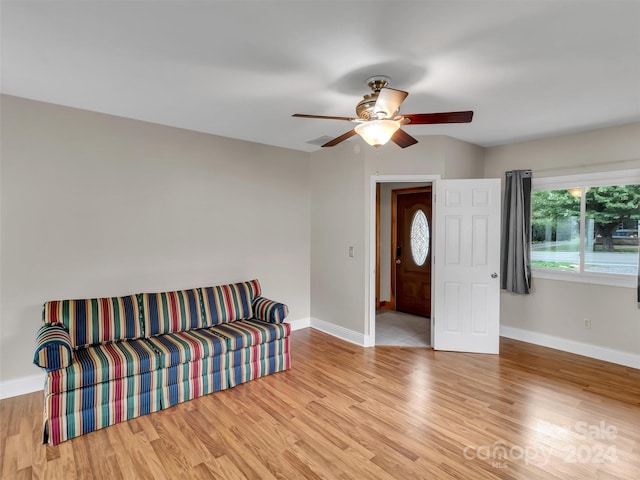 sitting room with ceiling fan and light hardwood / wood-style flooring