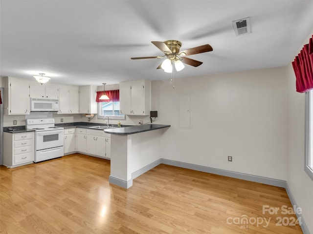 kitchen with light hardwood / wood-style floors, sink, white cabinets, kitchen peninsula, and white appliances