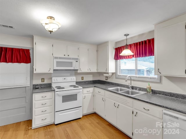 kitchen featuring light hardwood / wood-style flooring, white appliances, white cabinetry, and sink