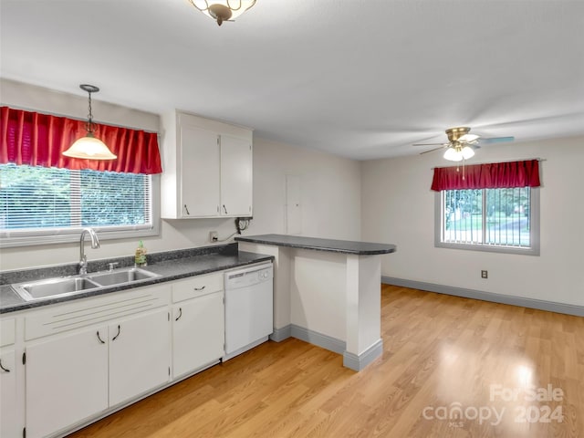 kitchen with white cabinets, dishwasher, sink, and a wealth of natural light