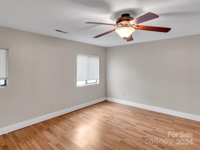 spare room with light hardwood / wood-style floors and ceiling fan