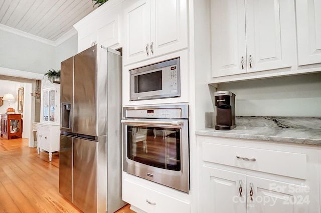 kitchen featuring light stone counters, white cabinetry, light hardwood / wood-style flooring, crown molding, and stainless steel appliances