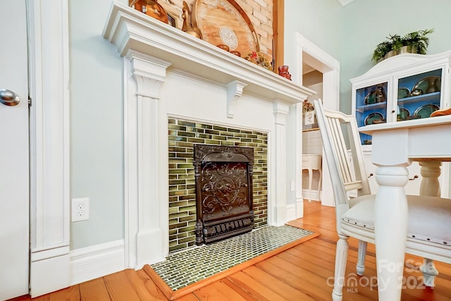 details with hardwood / wood-style flooring and a fireplace