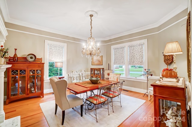 dining space featuring crown molding, a healthy amount of sunlight, and light wood-type flooring