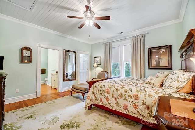 bedroom with crown molding, ensuite bathroom, light wood-type flooring, and ceiling fan