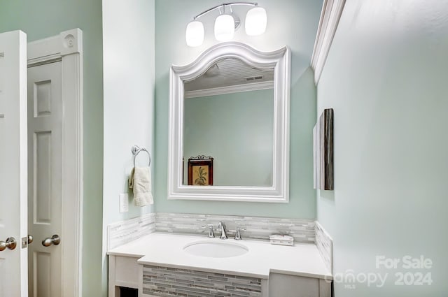 bathroom featuring vanity and crown molding