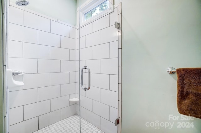 bathroom featuring a shower with door