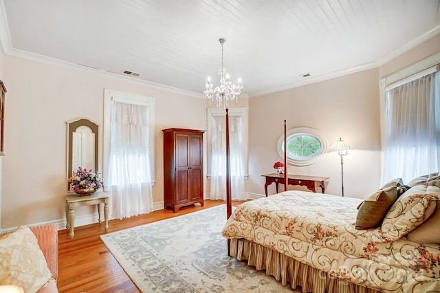 bedroom featuring ornamental molding, light hardwood / wood-style flooring, and a notable chandelier