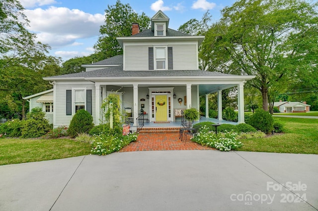 farmhouse-style home with a porch and a front yard