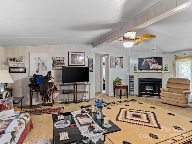 carpeted living room with ceiling fan, vaulted ceiling with beams, and wooden walls