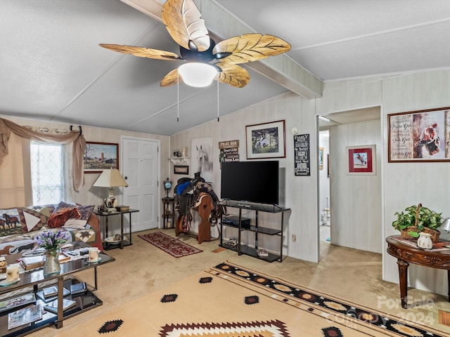 living room featuring ceiling fan, lofted ceiling with beams, and carpet flooring