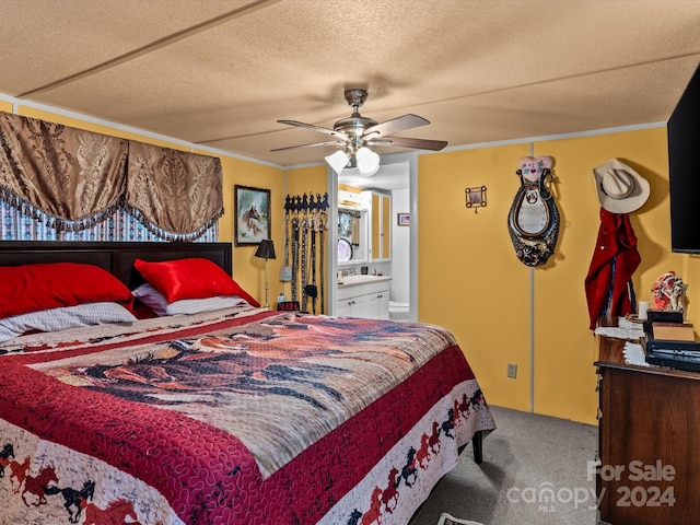 bedroom with ceiling fan, crown molding, ensuite bath, and carpet