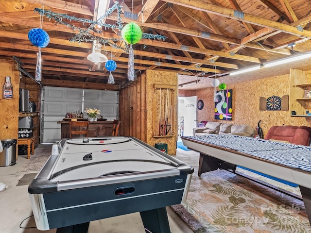 recreation room with lofted ceiling with beams and concrete floors