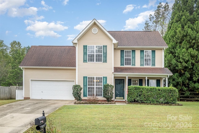 view of front of house with a garage and a front lawn