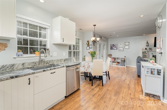 kitchen featuring hanging light fixtures, white cabinetry, sink, and dishwasher