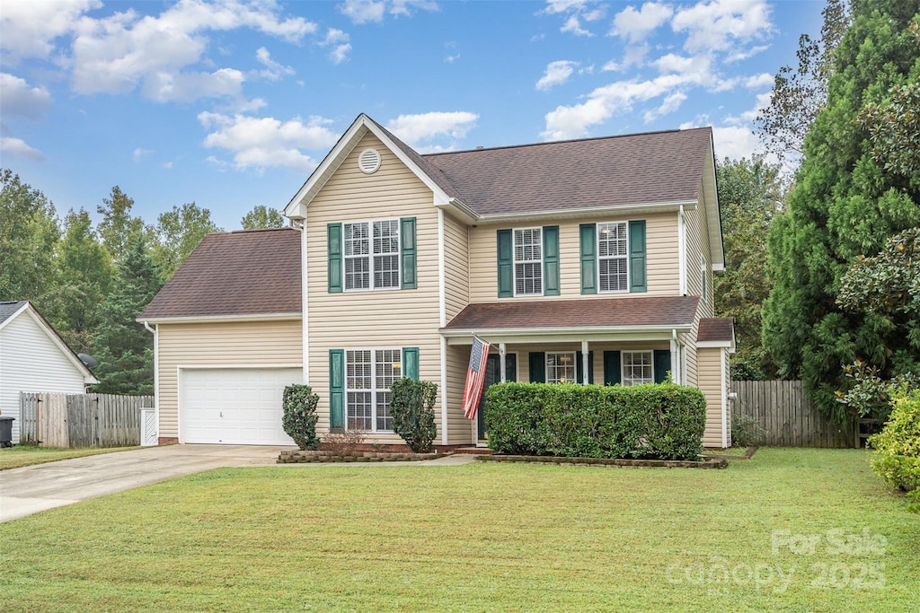 view of front of property featuring a front lawn and a garage