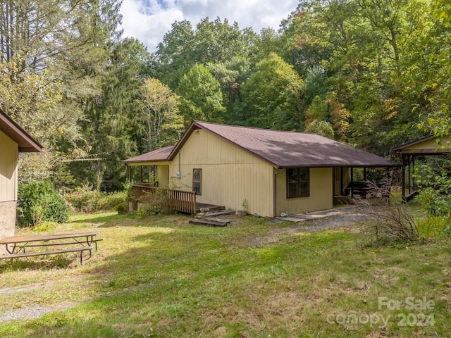 view of side of home with a lawn