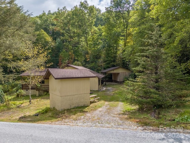 view of side of property with a storage unit